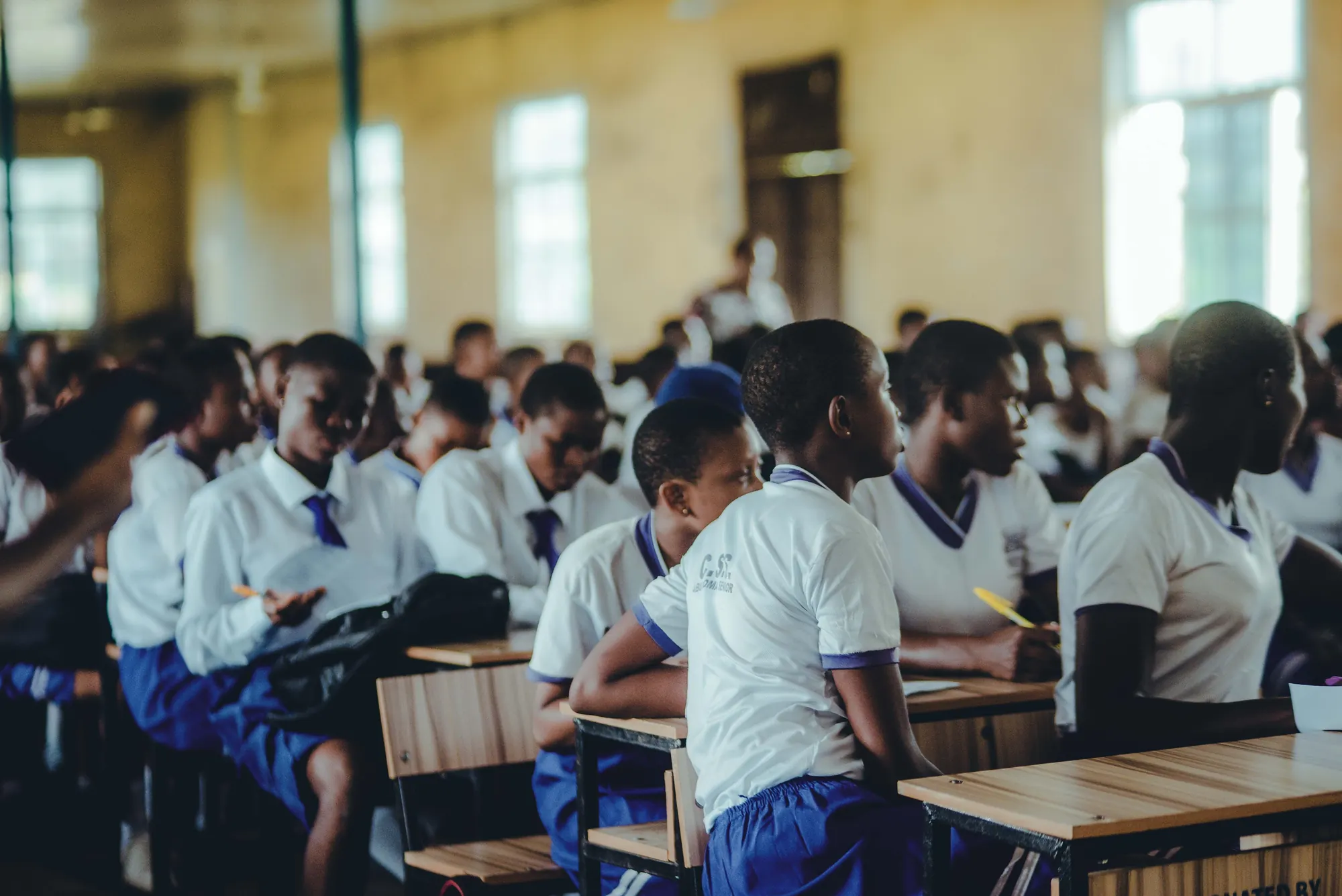 Rows of secondary school students in uniform at their desks